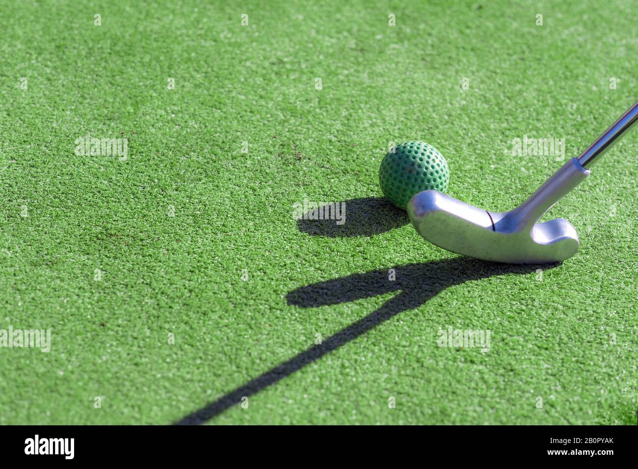 Mini golf club, ball and hole Stock Photo