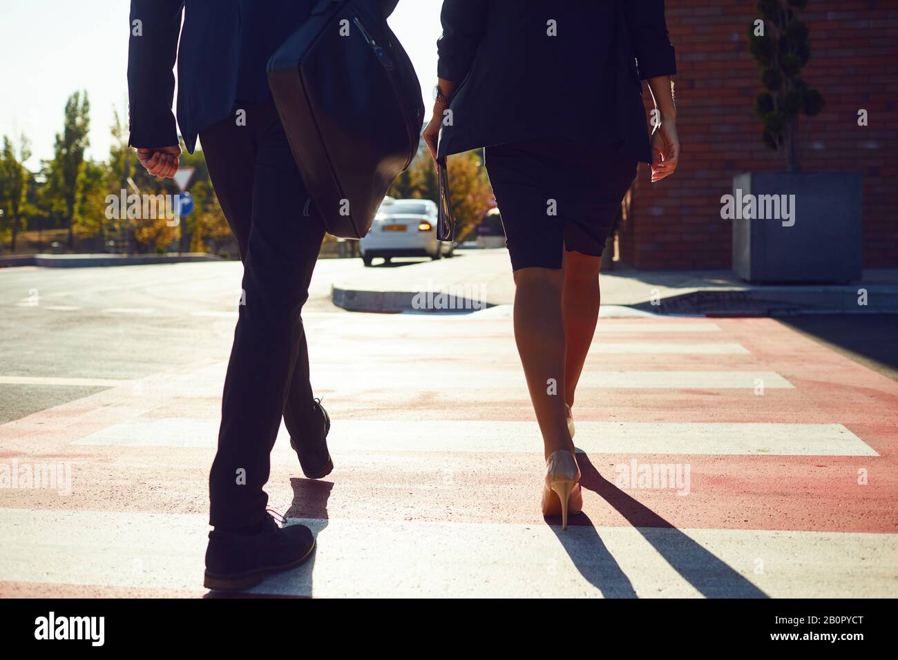 Back view. Business People walk along the city street. Stock Photo