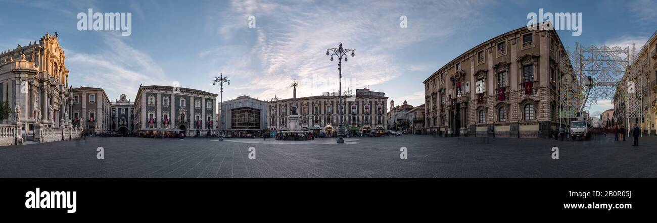 Catania's central square at sunset, with Sant'Agata church, the town hall and the elephant fountain in a panoramic picture, Catania, Sicily, Italy Stock Photo