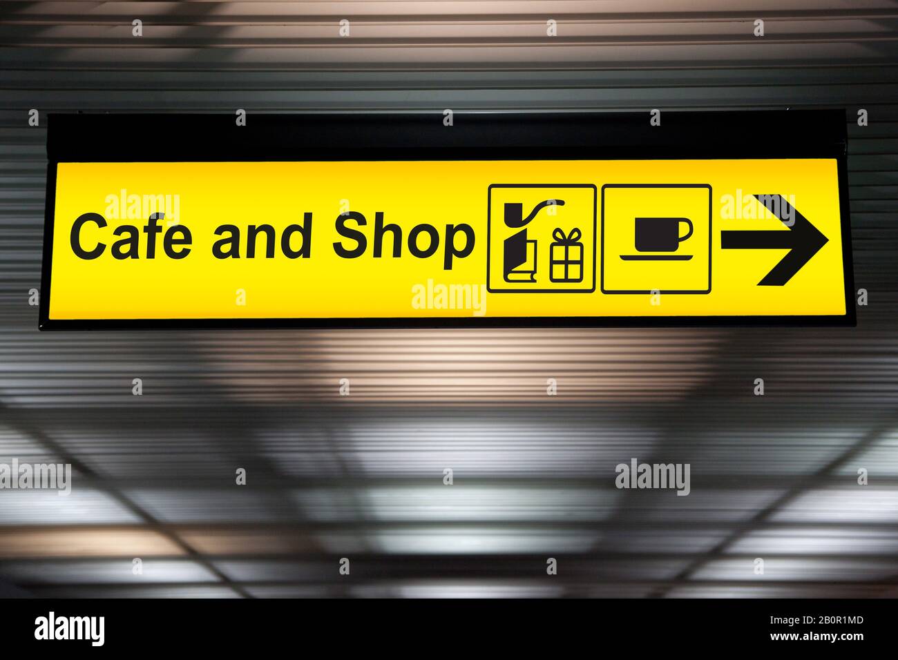 sign cafe and shop with arrow for direction for passenger to buy food , drink and shopping. yellow cafe and shop sign at the airport Stock Photo
