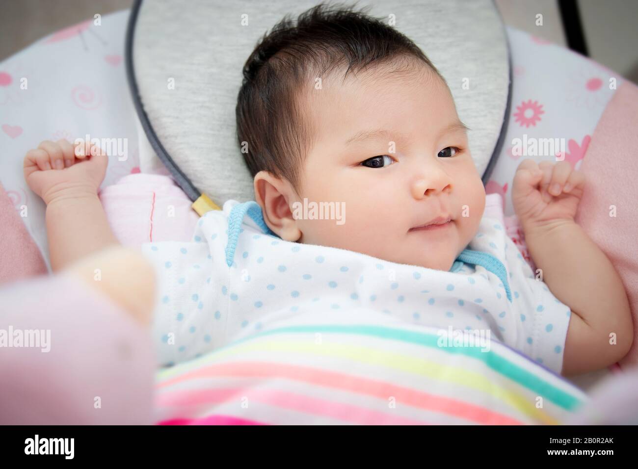 adorable cute Asian baby lay down for sleep on bed at bedtime on a comfortable soft mattress. Stock Photo