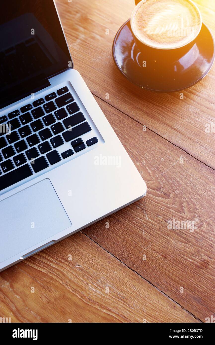 work space concept. laptop, top view of workplace with laptop on wood table with coffee cup with copy space for your text Stock Photo