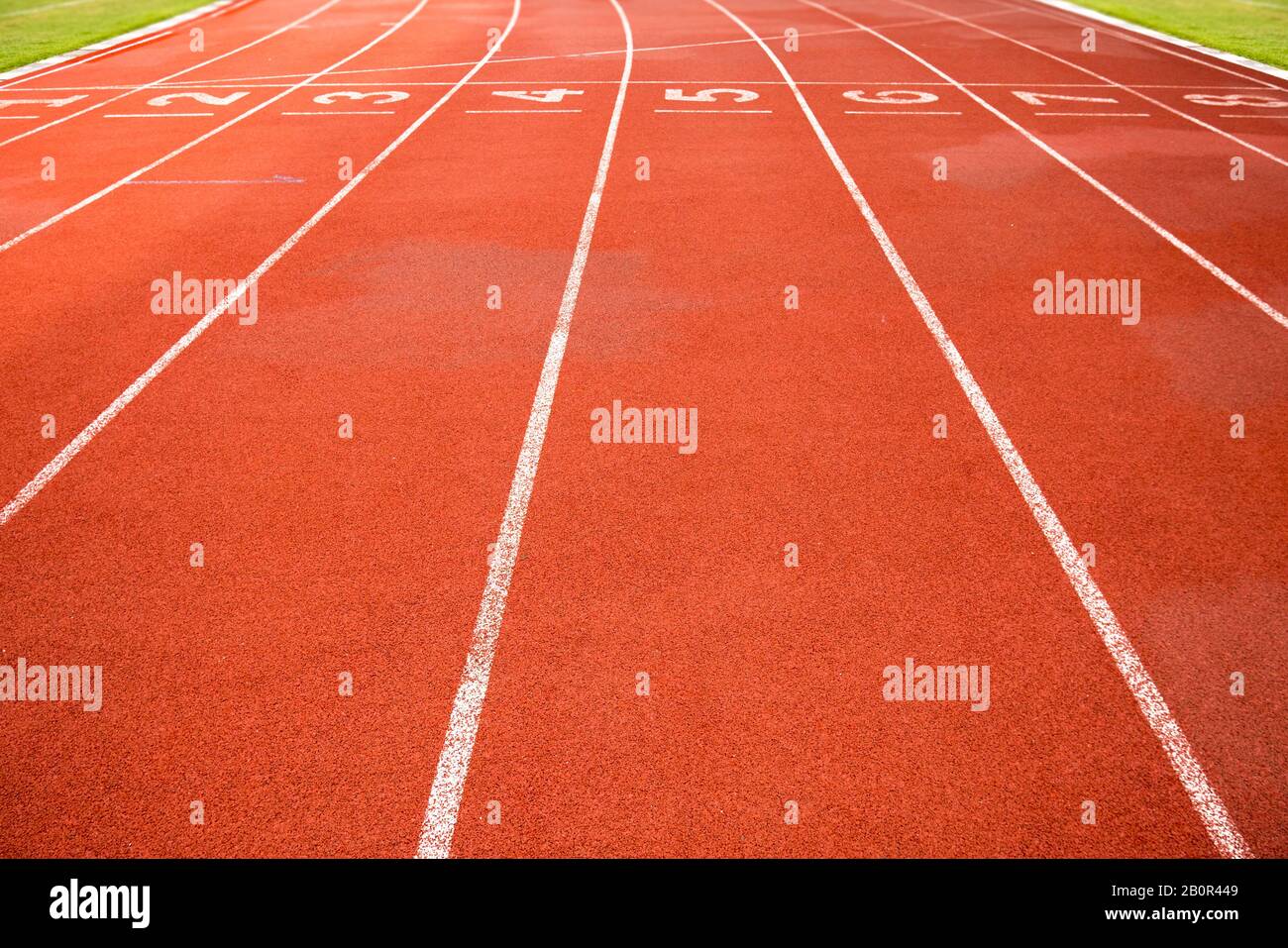 Sport, game, competition and exercise concept.red rubber racetracks running lane with number and line in white color. Jogging track, outdoor stadium Stock Photo