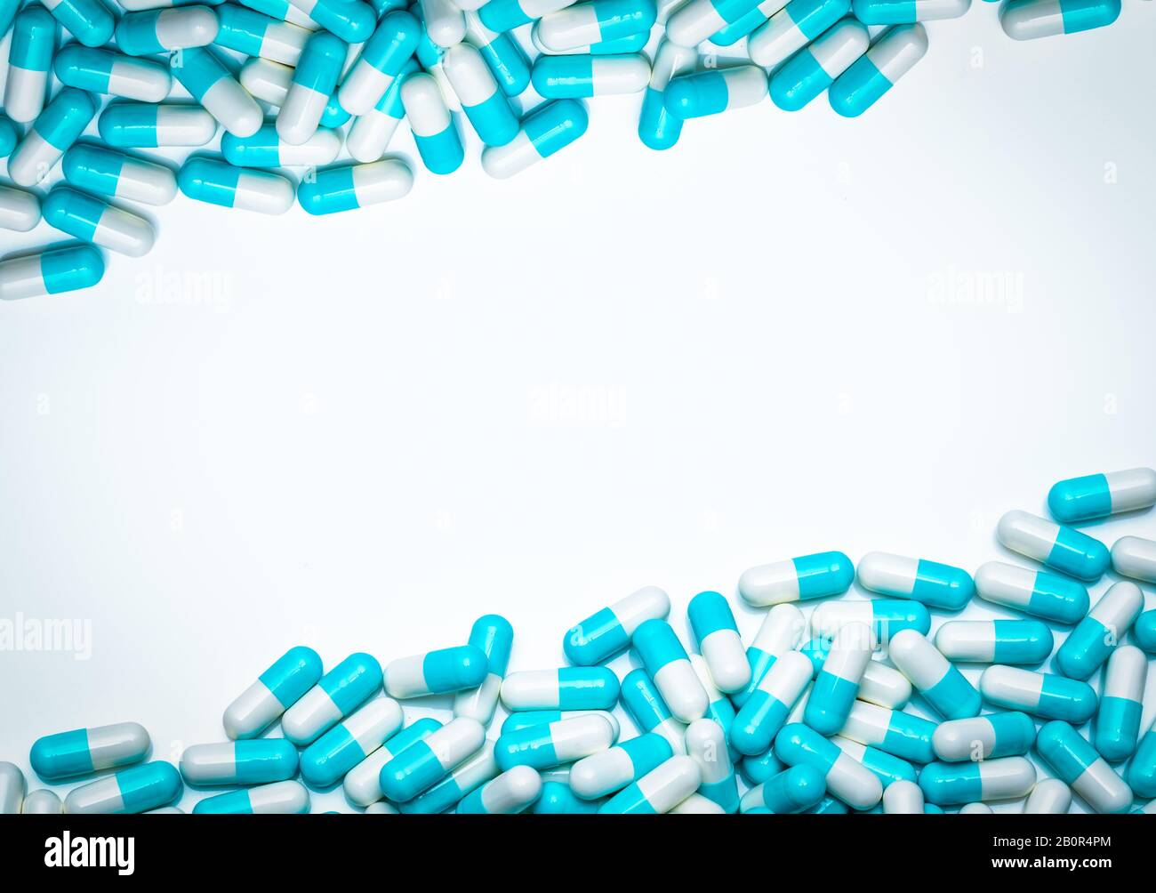 Blue-white antibiotic capsule pills on white background. Antibiotic drug resistance concept. Pharmaceutical industry. Antimicrobial medicine. Pharmacy Stock Photo