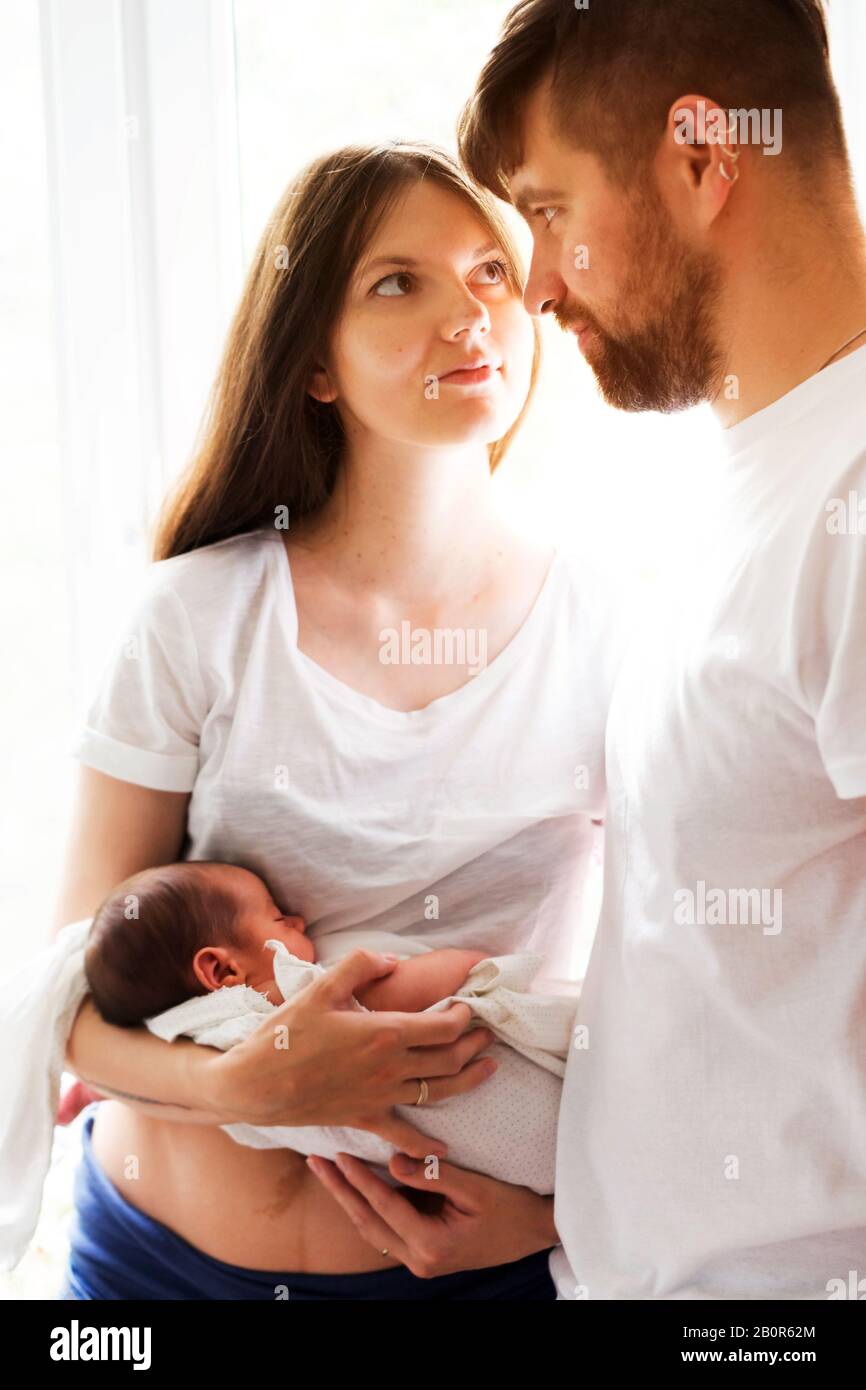 Father and mother with a newborn son. New multi generation young family Stock Photo
