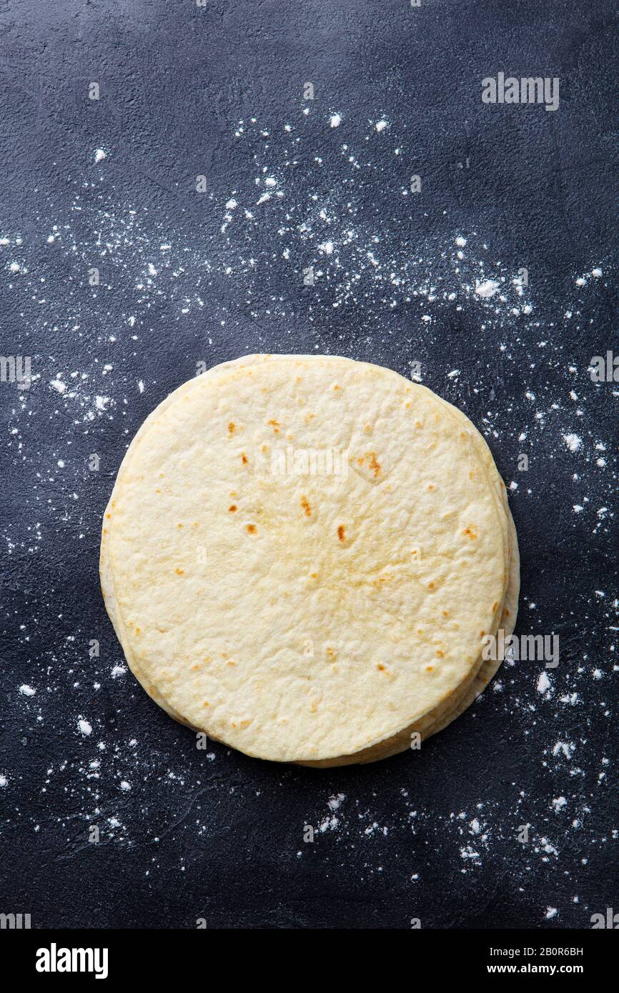 Tortillas, flat breads on dark grey background. Copy space. Top view. Stock Photo