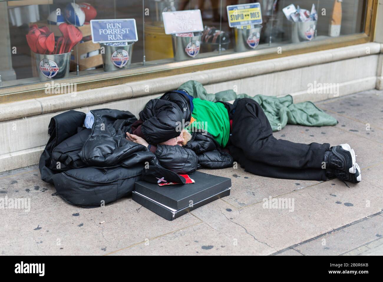 Street Photography Homeless Sleeping on the Street in front of a Store