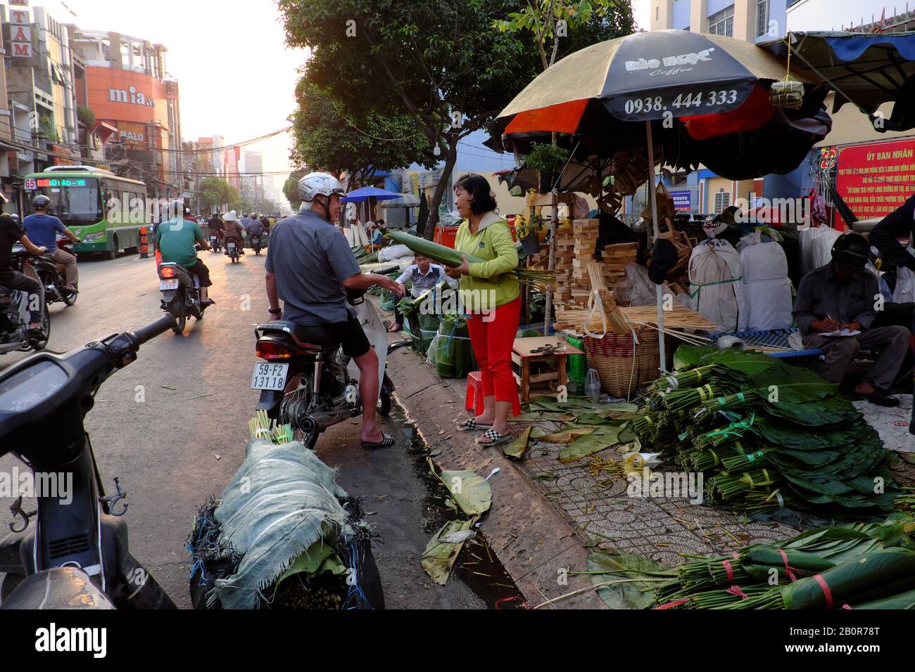 HO CHI MINH CITY, VIET NAM- JAN 15, 2020: Traditional leaf market near Tet for people buy leaves, bamboo rope, cake mold for make glutinous rice cake, Stock Photo