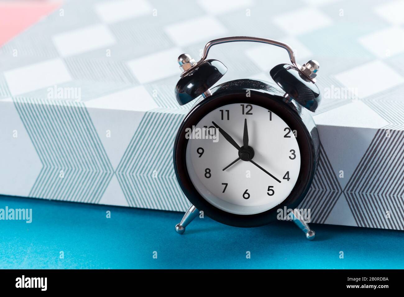 Vintage background with retro alarm clock on table Stock Photo - Alamy