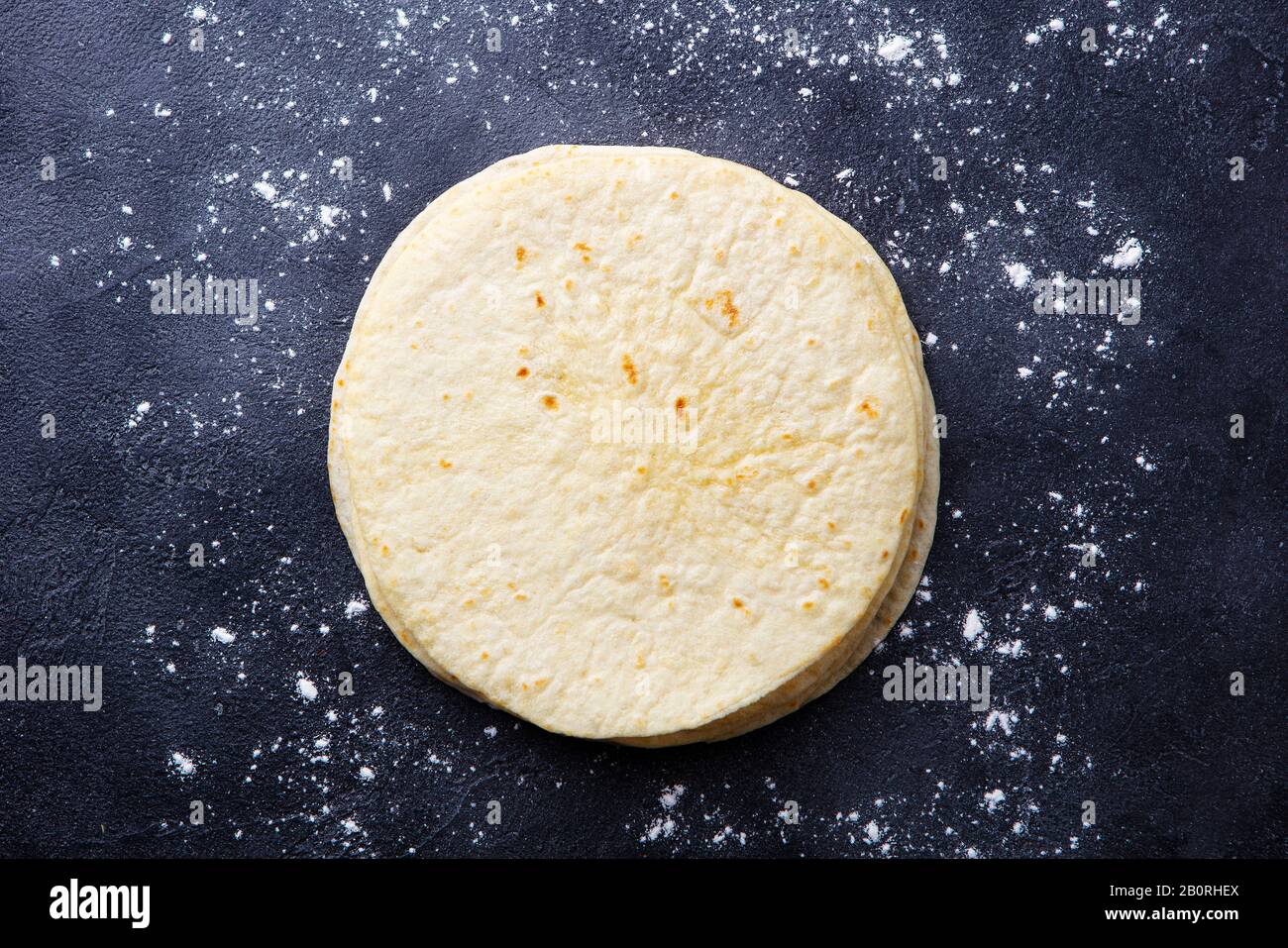 Tortillas, flat breads on dark grey background. Copy space. Top view. Stock Photo