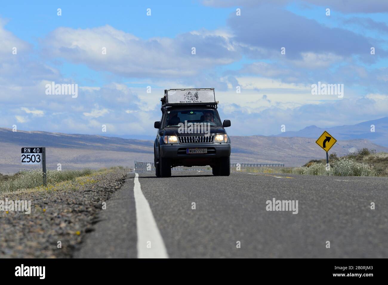 Off-road vehicle, Toyota Land Cruiser, at a kilometre indication of the Ruta 40, at Chos Malal, Neuquen Province, Patagonia, Argentina Stock Photo