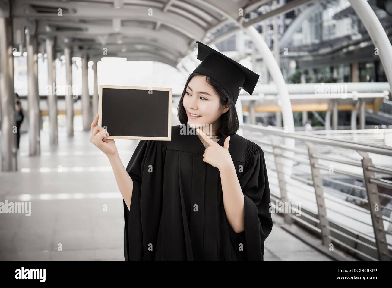 Female graduate holding placard hi-res stock photography and images - Alamy