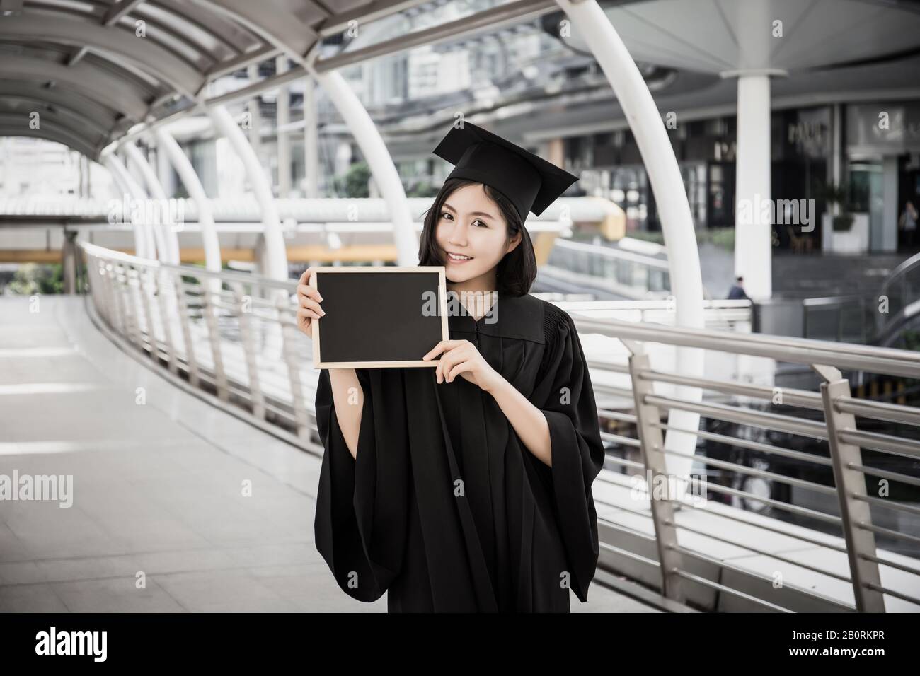 Female graduate holding placard hi-res stock photography and images - Alamy