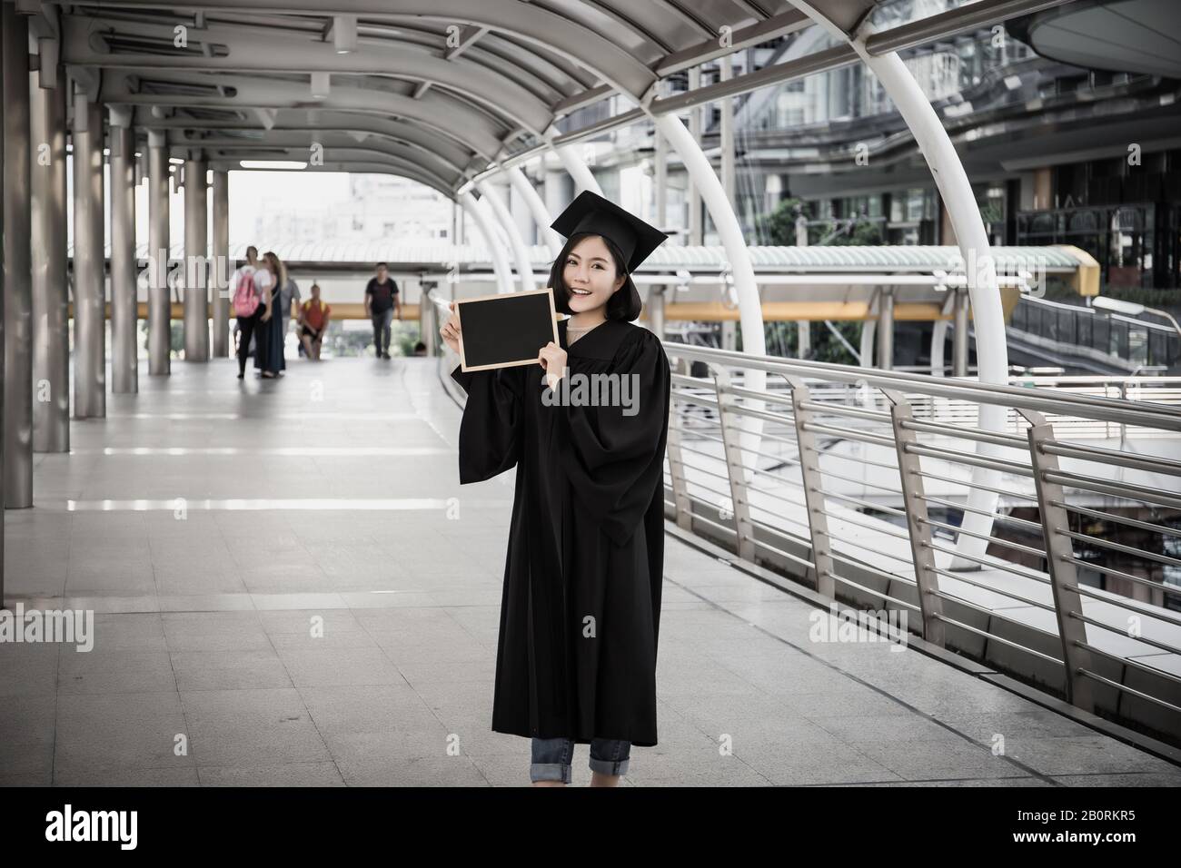 Female graduate holding placard hi-res stock photography and images - Alamy