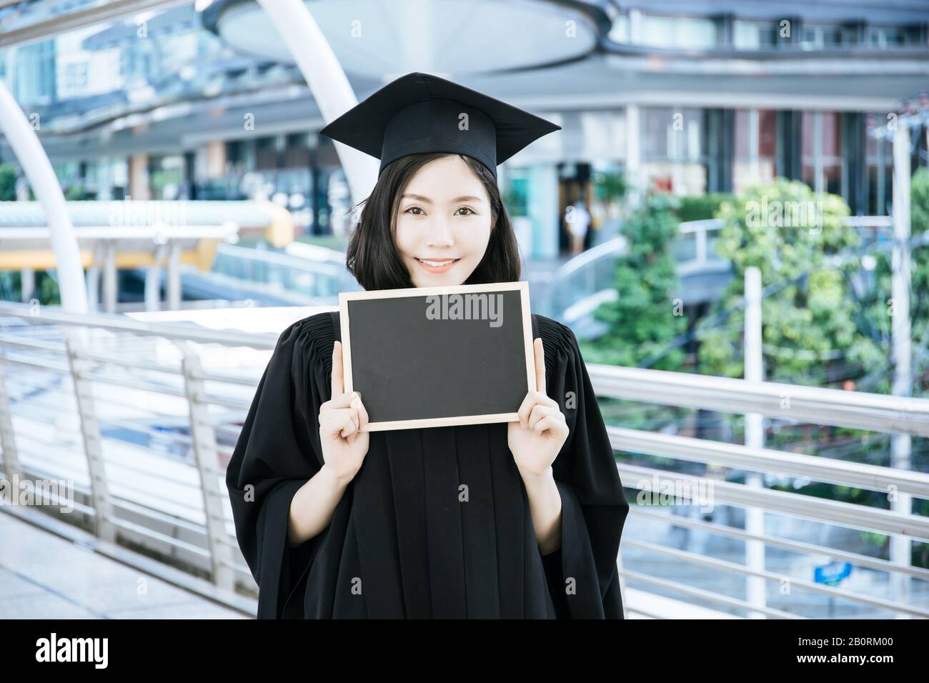 Female graduate holding placard hi-res stock photography and images - Alamy