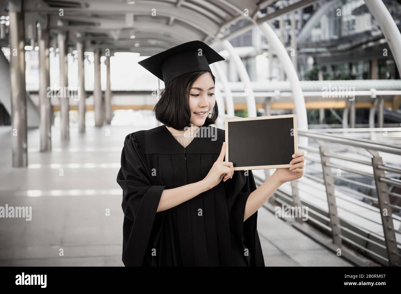 Female graduate holding placard hi-res stock photography and images - Alamy