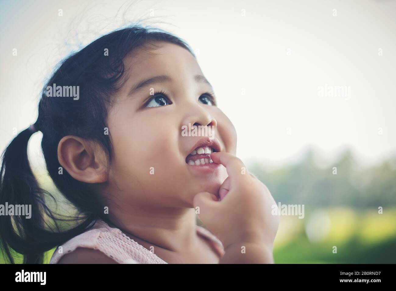 Portrait of little girl smiling showing happy in the park Stock Photo ...