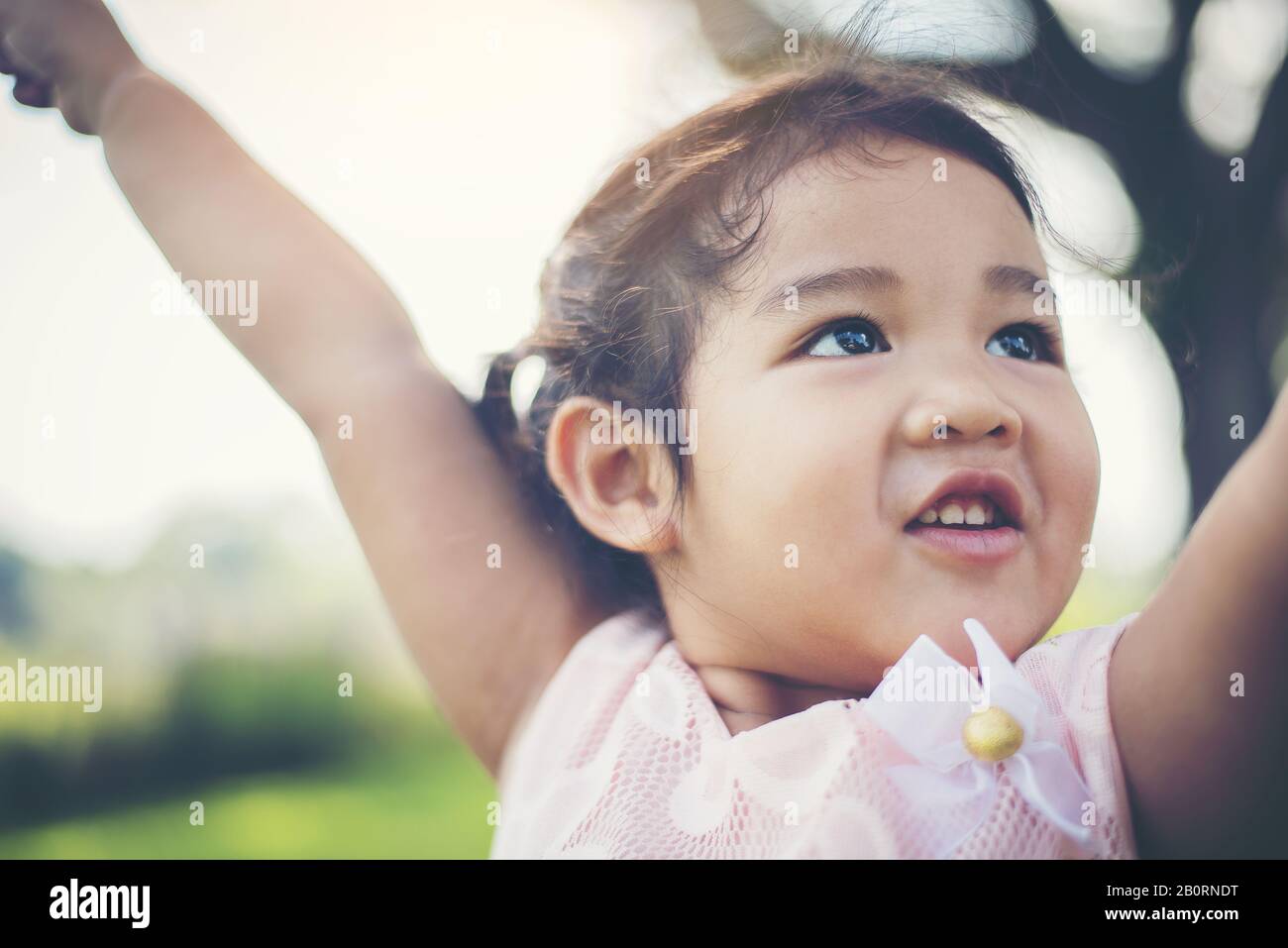 Portrait of little girl smiling showing happy in the park Stock Photo ...