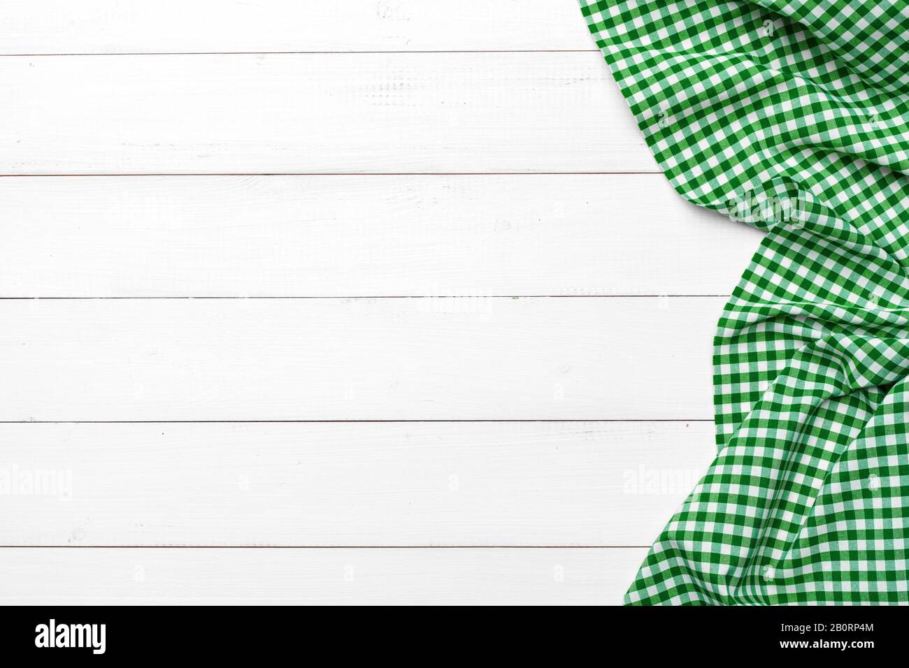 checkered tablecloth on wooden table. creative photo. Stock Photo