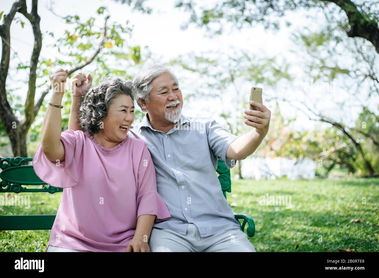 Senior couple taking a selfie photo with smart phone in a park Stock ...
