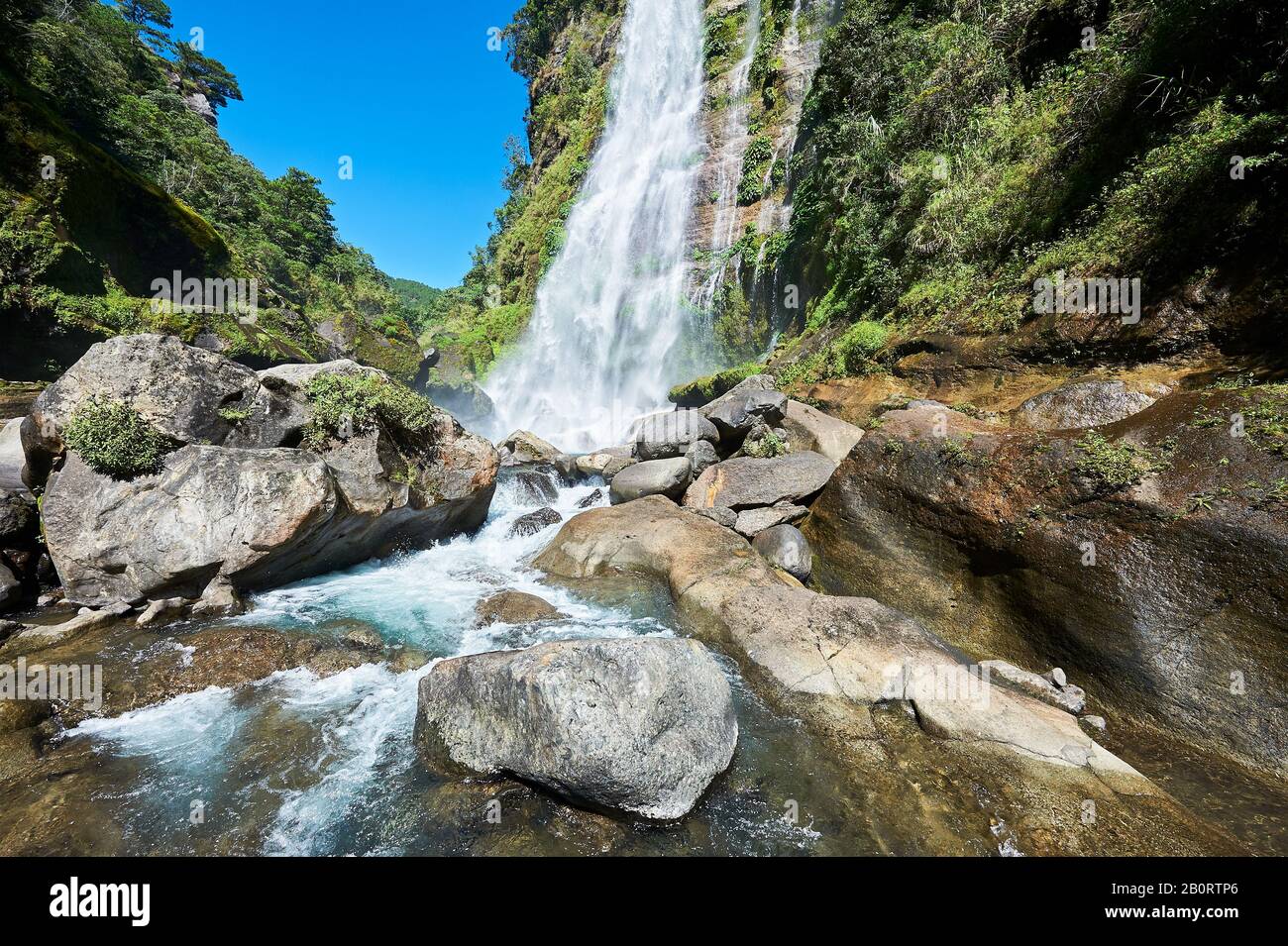 Sagada, Mountain Province, Philippines: Scenic wide angle view of Bomod-ok Waterfalls, Banga-an, surrounded by lush vegetation Stock Photo