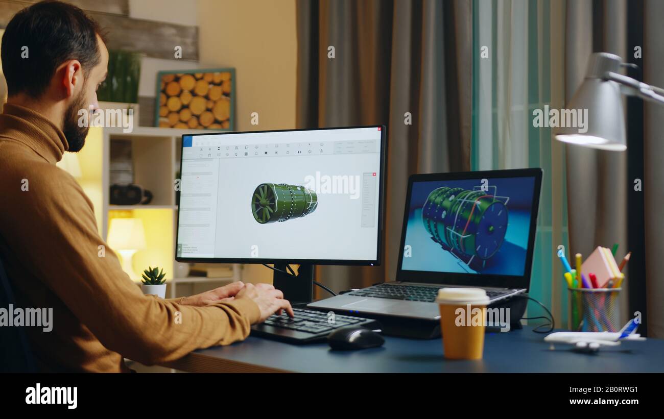 Handsome engineer in his home office developing a new turbine. Creative freelancer. Stock Photo