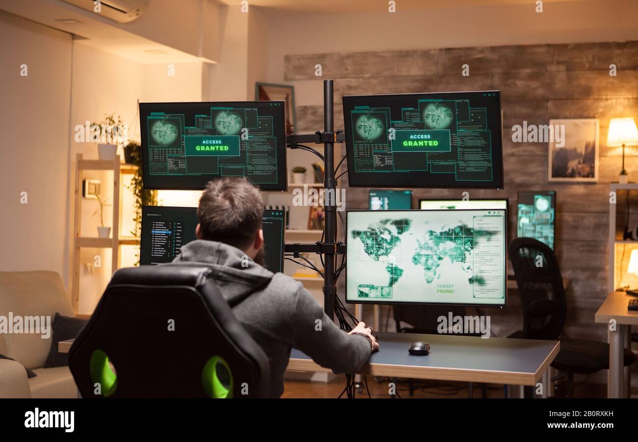 Dangerous hacker happy after gets access granted after a cyber attack. Stock Photo