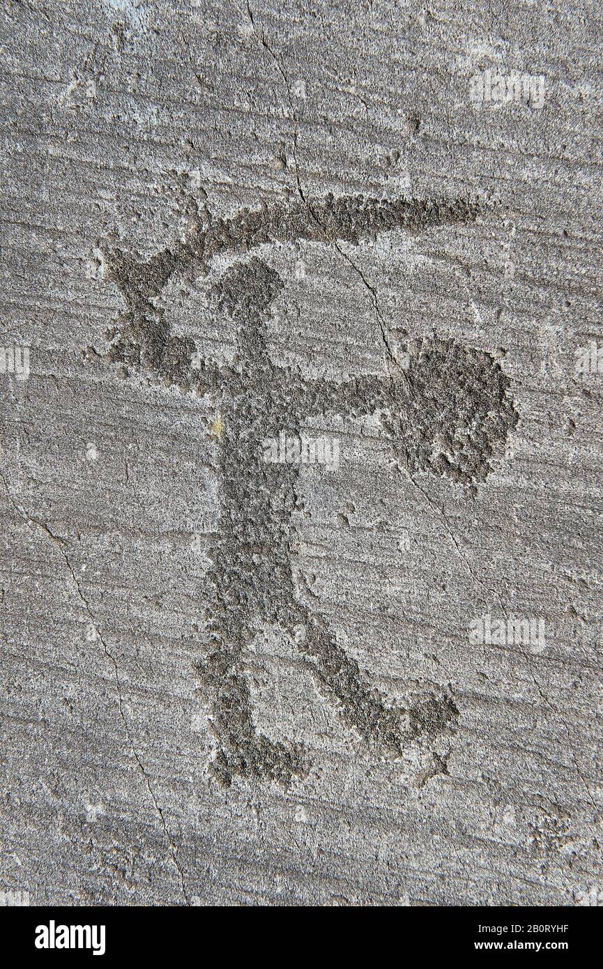 Petroglyph, rock carving, of a warriors with a shield and sword. Carved by the ancient Camuni people in the iron age between 1000-1200 BC. Rock no 6, Stock Photo