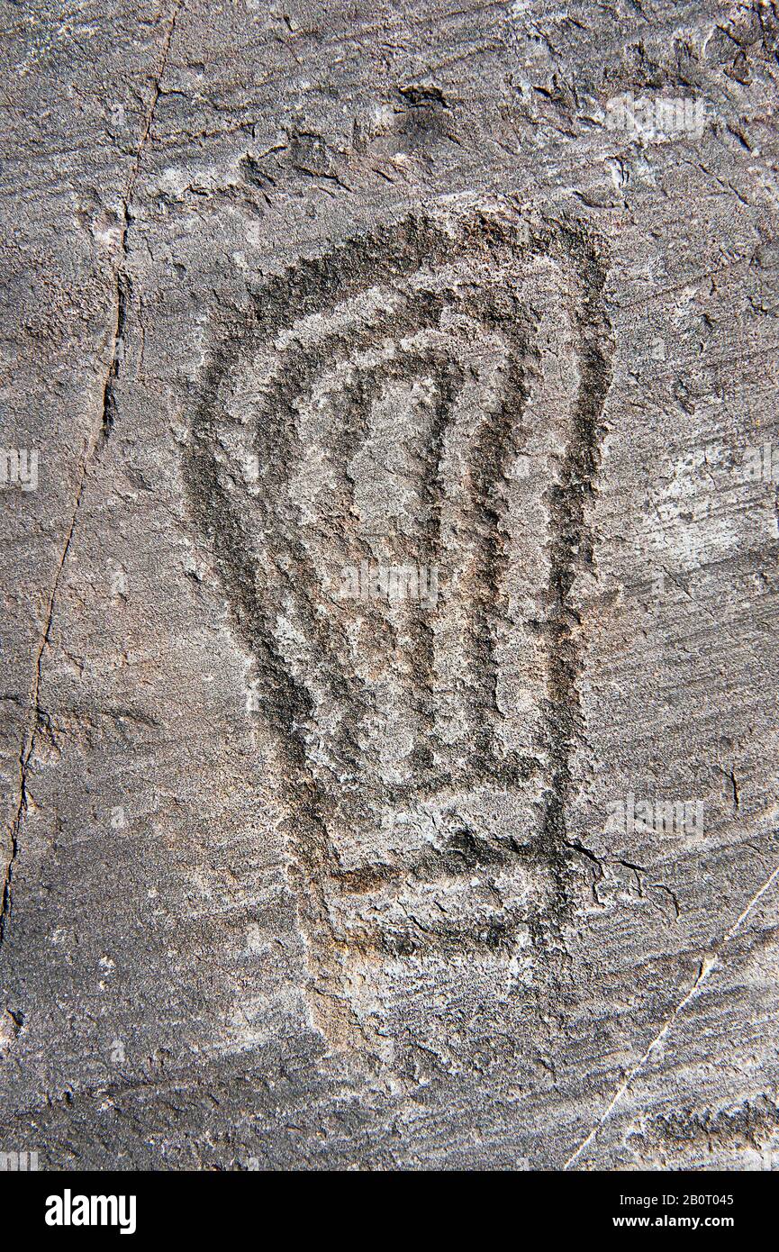 Petroglyph, rock carving, carved by the ancient Camunni people in the iron age between 1000-1200 BC. Foppi di Nadro, Rock no 24, Riserva Naturale Inci Stock Photo