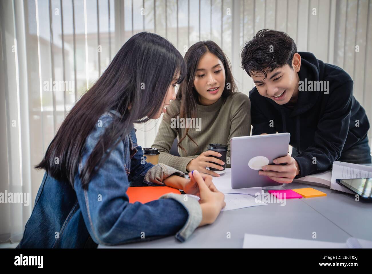 Group Asian Students Smile And Reading Book And Using Notebook For Helps To Share Ideas In The Work And Project And Also Review The Book Before The Stock Photo Alamy