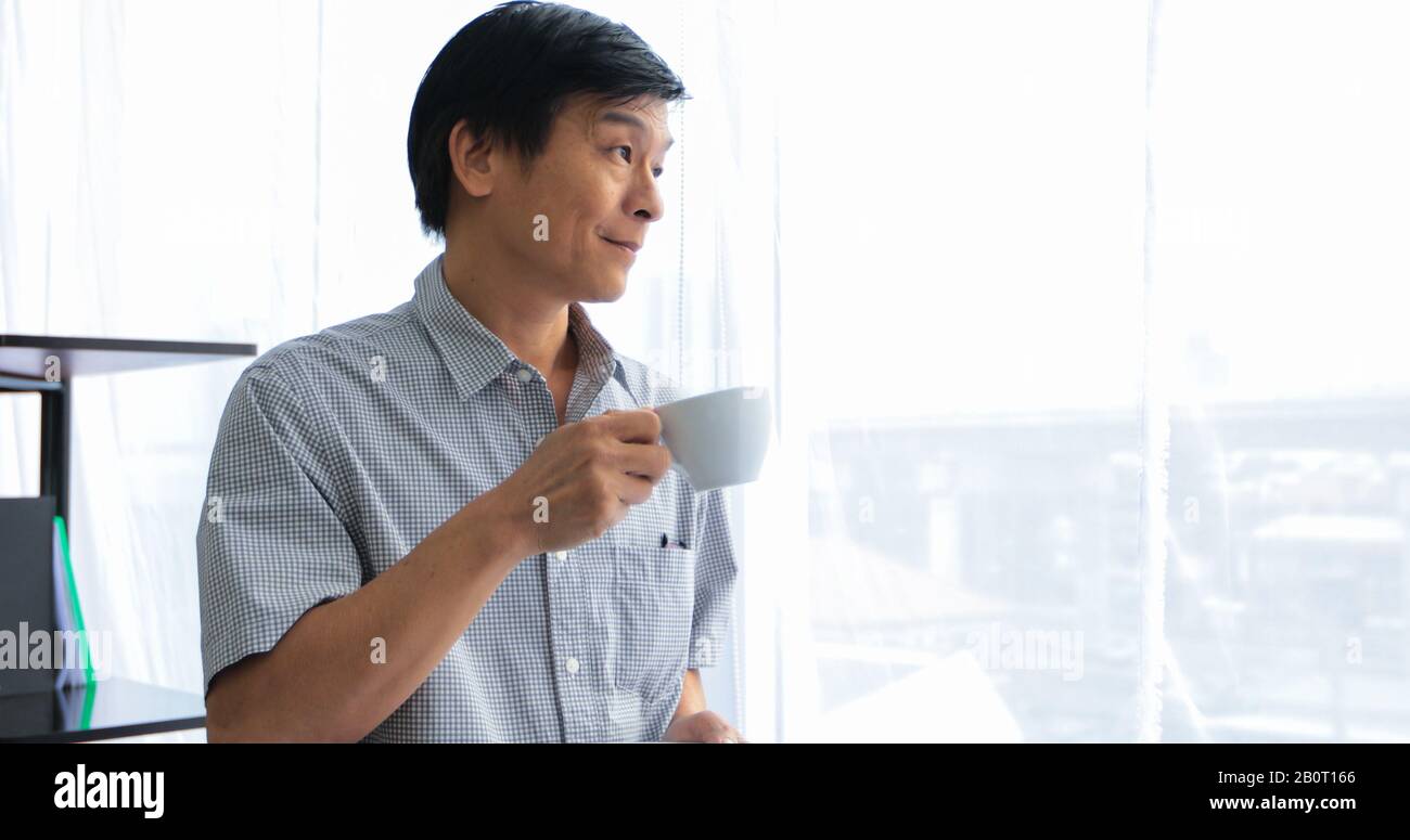 Senior Asian man drinking coffee on relaxing time Stock Photo