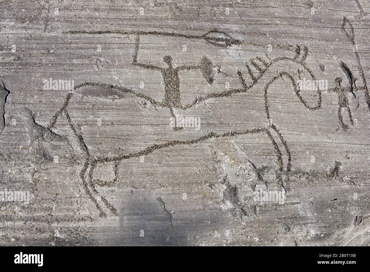 Petroglyph, rock carving, of a man with a spear on a horse carved by the ancient Camuni people in the iron age between  900-1200 BC. Rock 26-27, Foppi Stock Photo