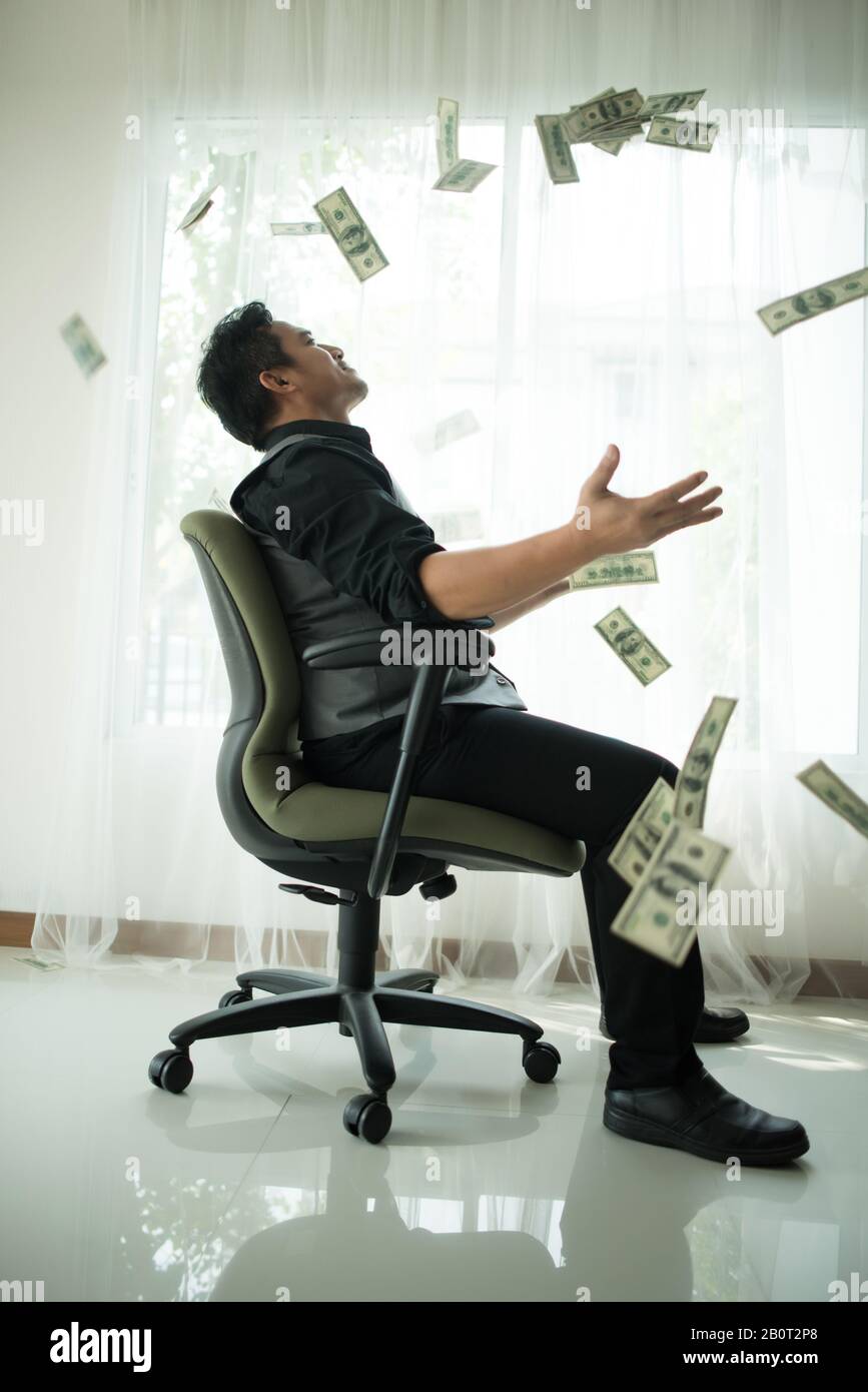 Happy business man very rich guy throw money dollar bills in air like