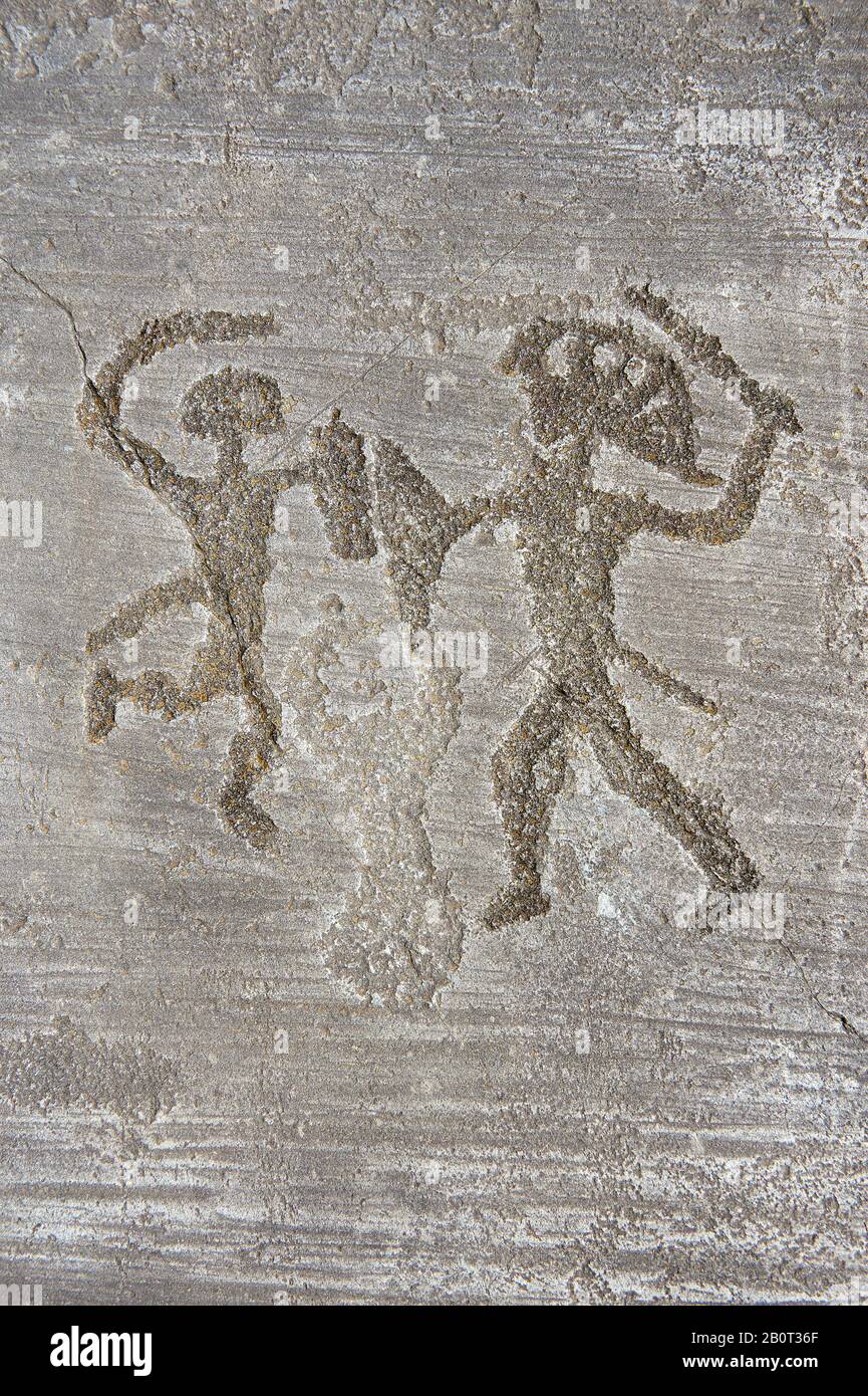 Petroglyph, rock carving, of two feet outlines. Carved by the ancient Camunni people in the iron age between 1000-1200 BC. Foppi di Nadro, Riserva Nat Stock Photo