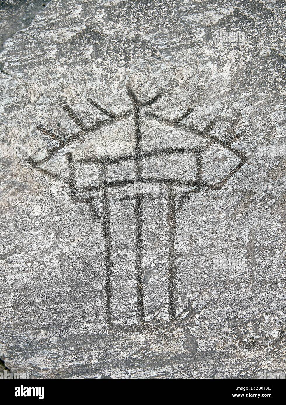 Prehistoric Petroglyph, rock carving, of a hut raied on wooden ploes carved by the Camunni people in the ,iddle to late iron age between  900-1200 BC, Stock Photo