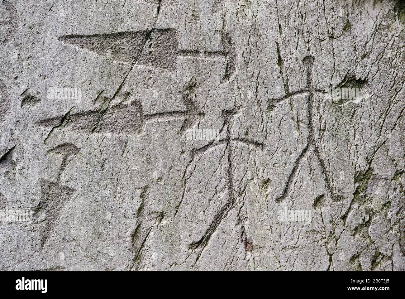 Prehistoric  petroglyphs, rock carvings, detail of of trangular daggers with semi circular pomels and schematic depictions of human figures in an anci Stock Photo