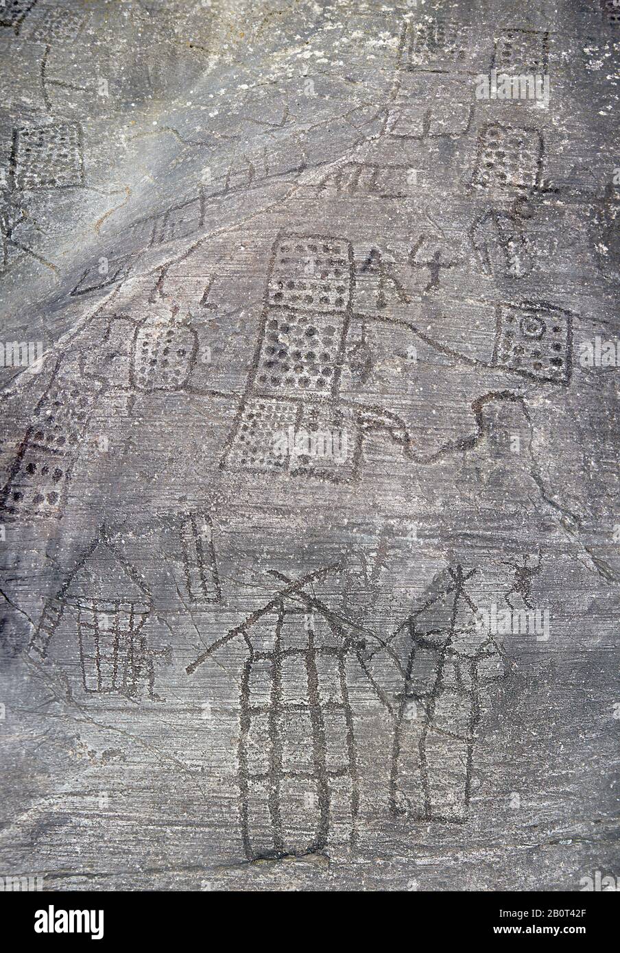 Prehistoric Petroglyph, rock carving, of what is known as the Map of Bebolina with depictions of huts raised on wooden poles and field systems carved Stock Photo