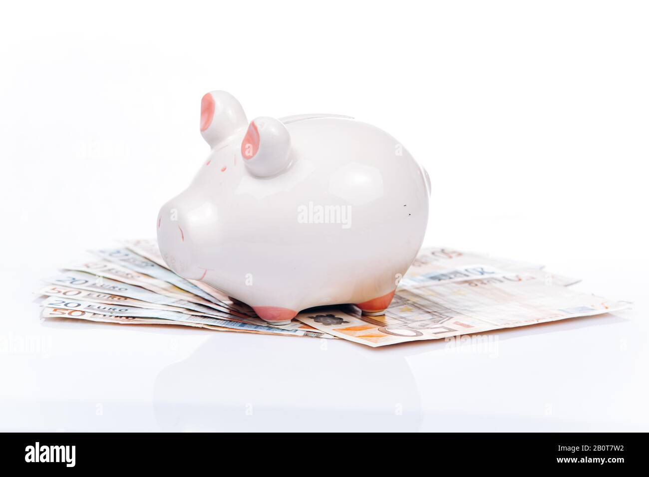 White piggy bank style money box on euros banknote Stock Photo - Alamy