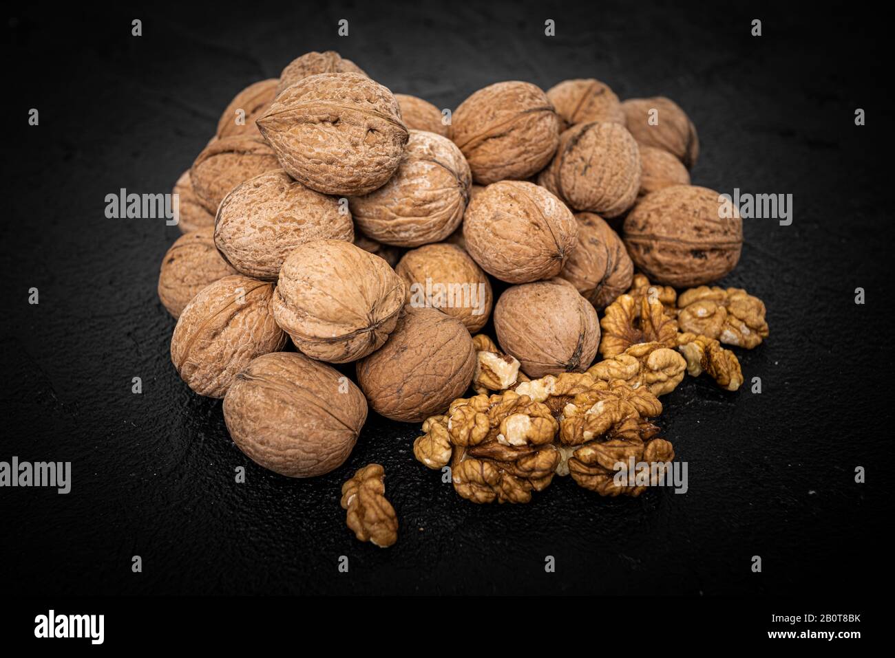 Walnut on over black slate stone background Stock Photo