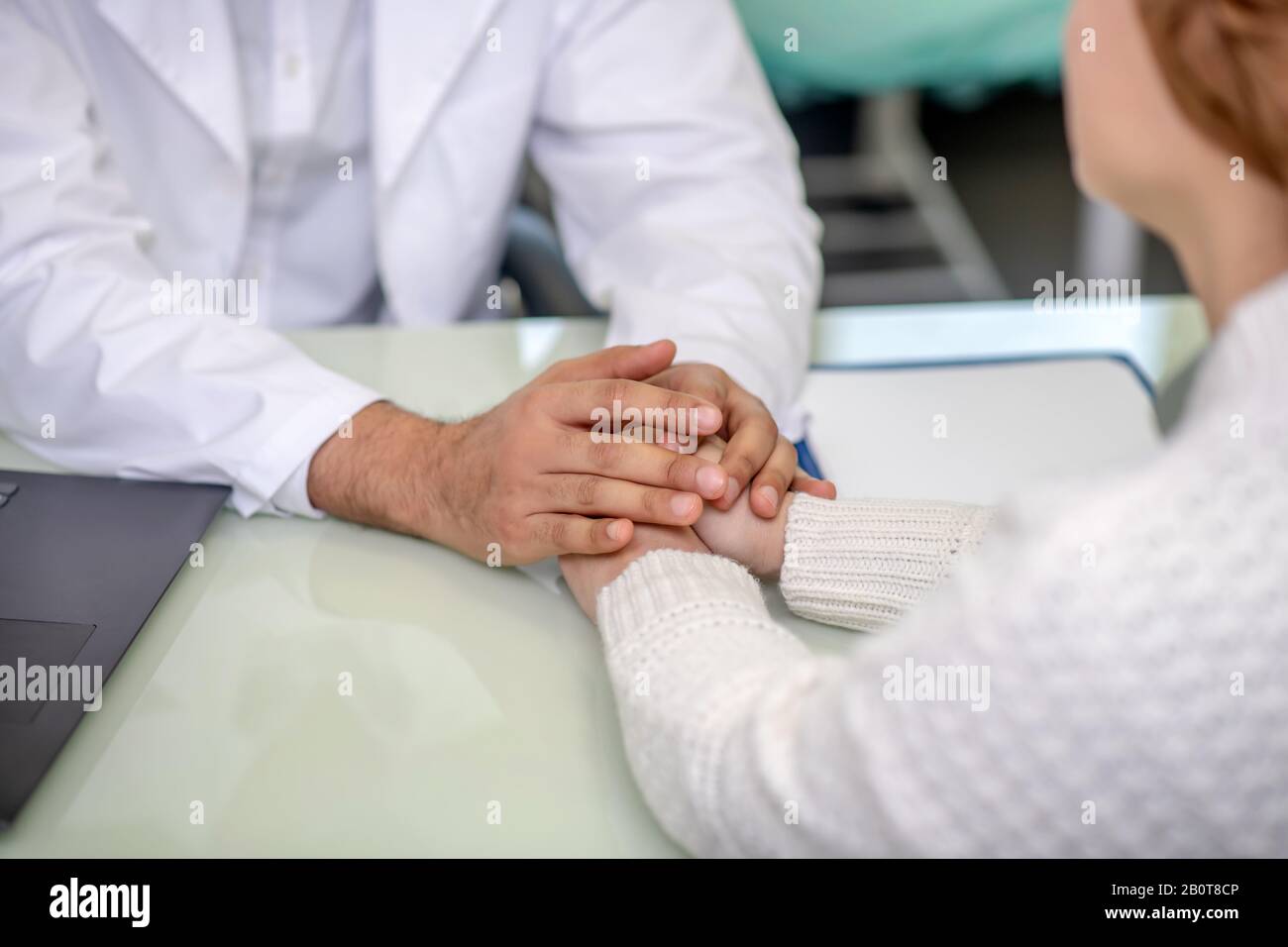 Close up picture of male hands holding his patients hands Stock Photo
