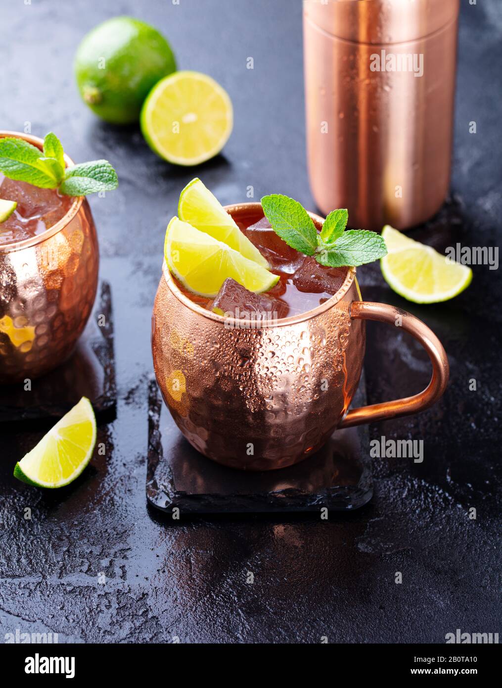 Cold Moscow Mules cocktail with ginger beer, vodka, lime and mint. Grey
