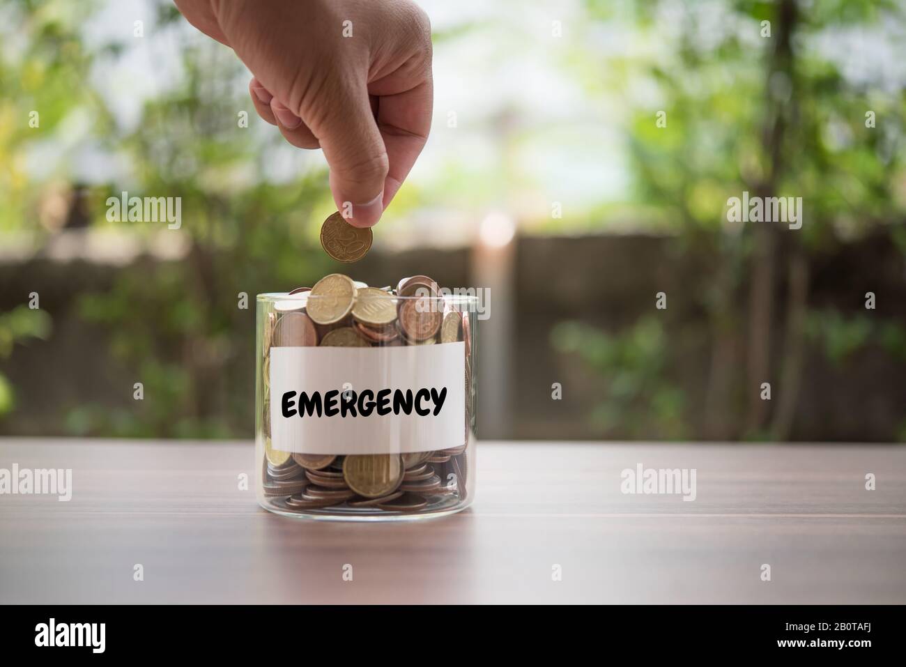 Hand putting coins in jar with money stack step growing growth saving ...