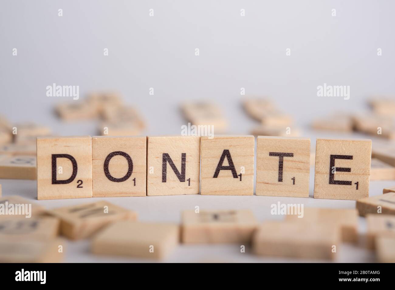 DONATE wooden tile font concept Stock Photo Alamy