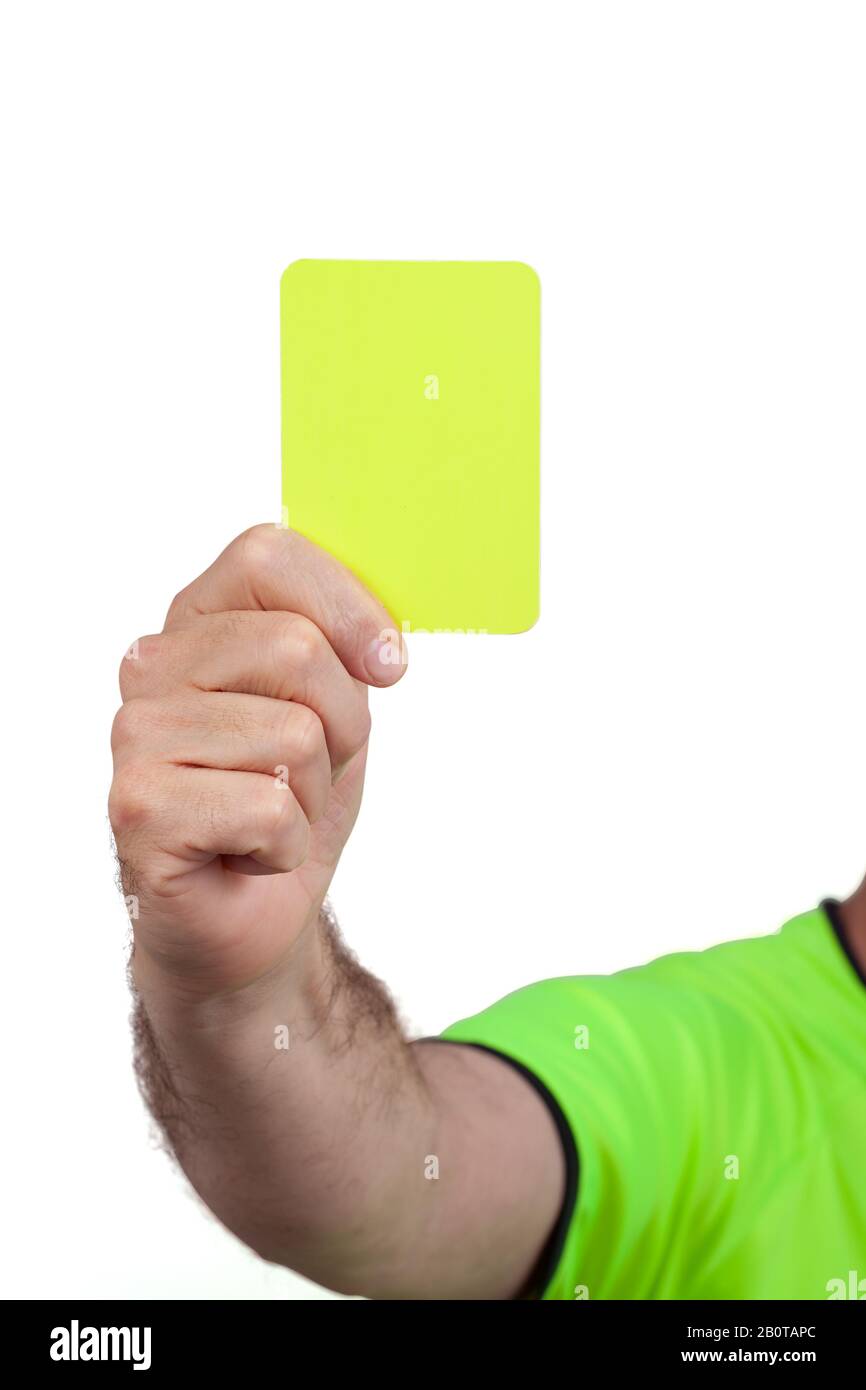Yellow card in football soccer referee hand isolated on white background. The image contains clipping path. Stock Photo