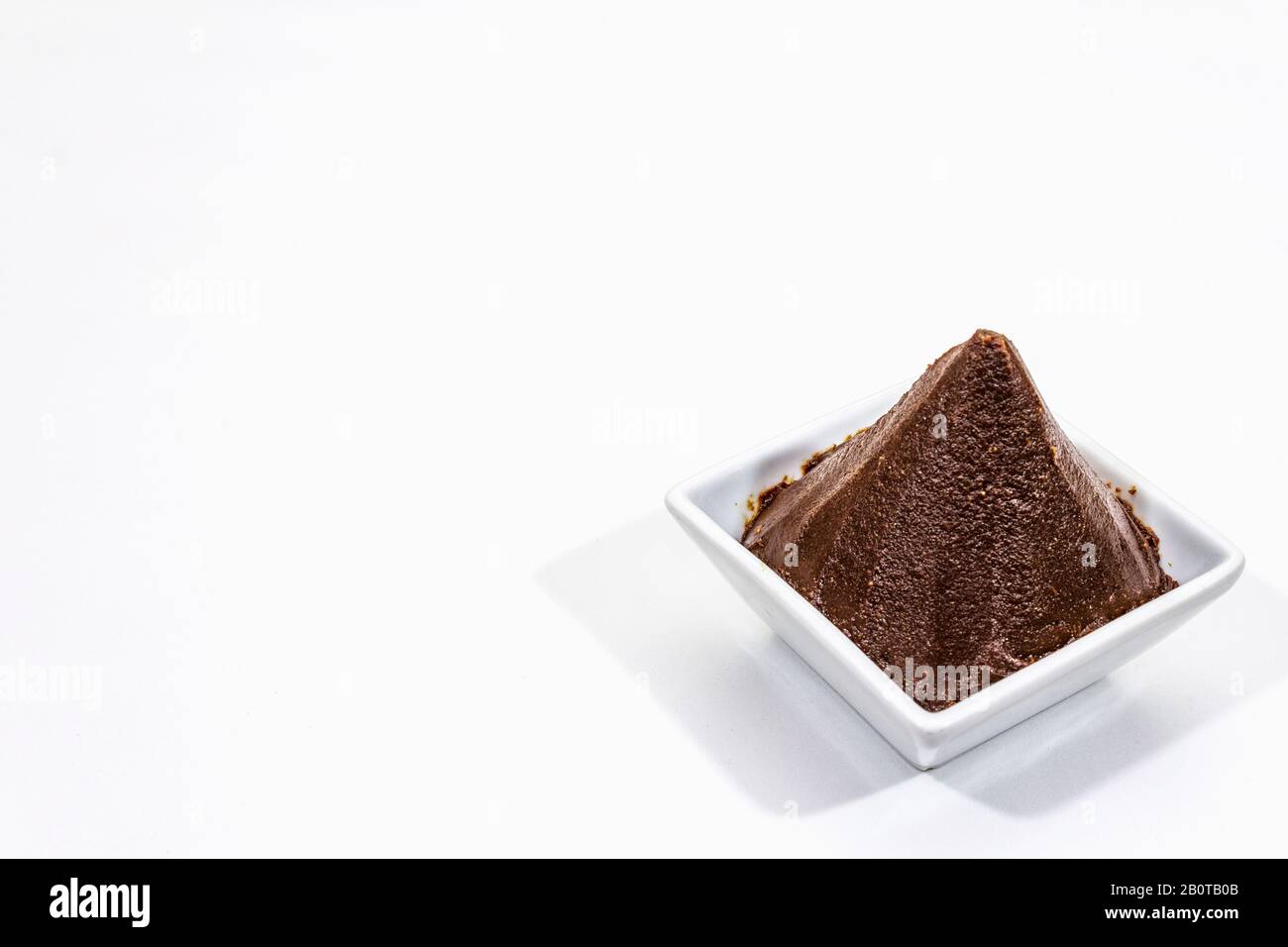 Dark brown miso paste isolated on white background. Traditional