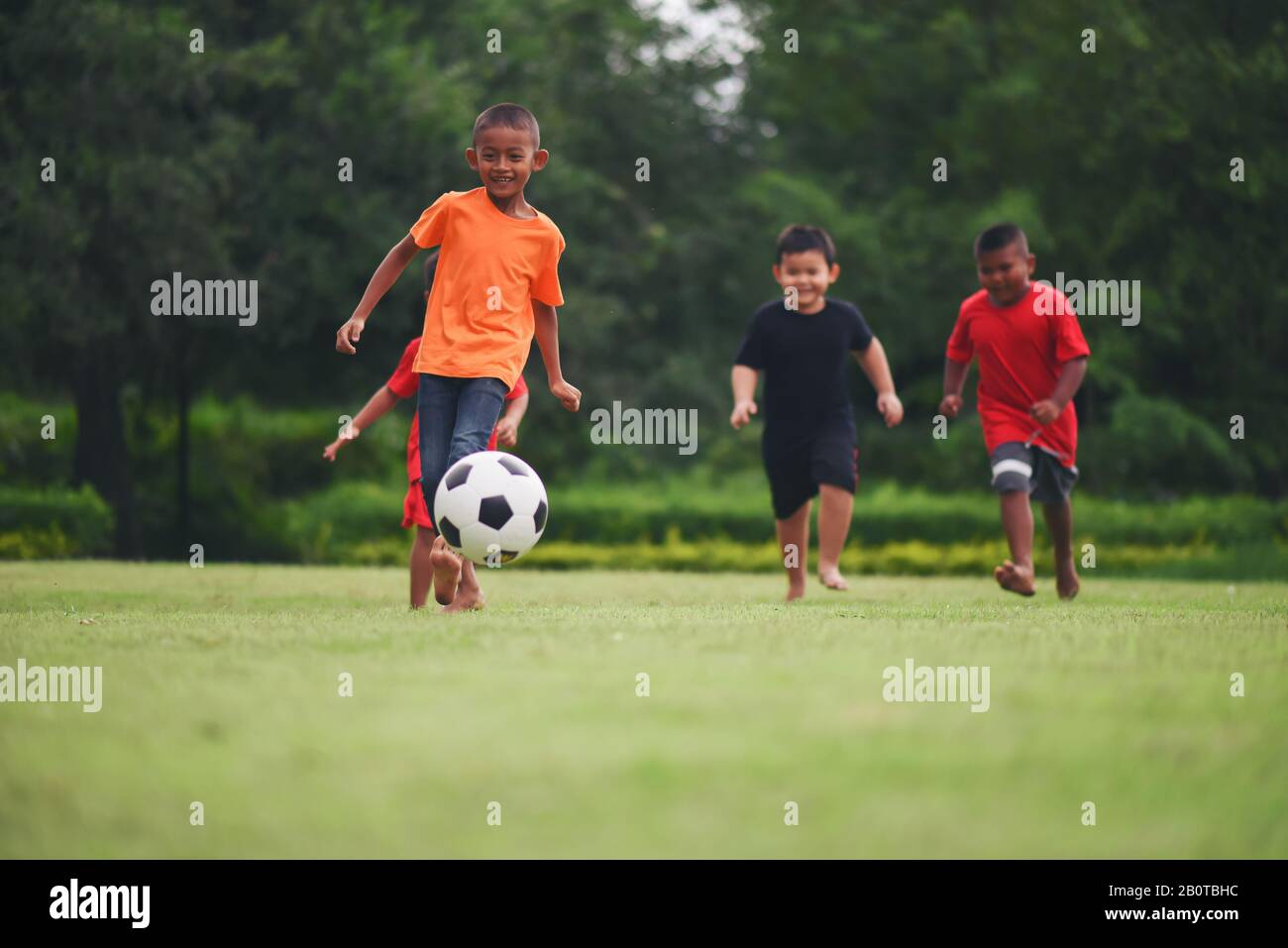 Kids playing soccer football Stock Photo Alamy