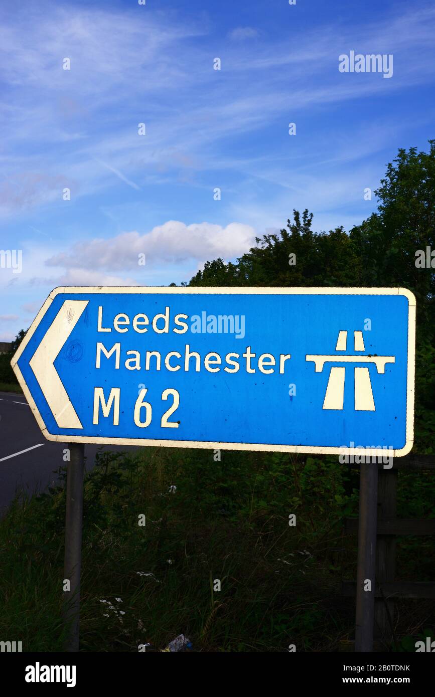 traffic passing m62 motorway sign to leeds and manchester at normanton junction leeds yorkshire uk Stock Photo