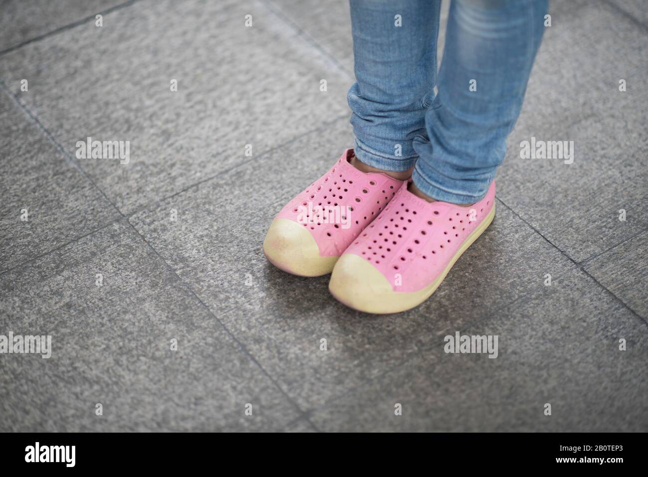 Close up picture of little girl feet in street Stock Photo