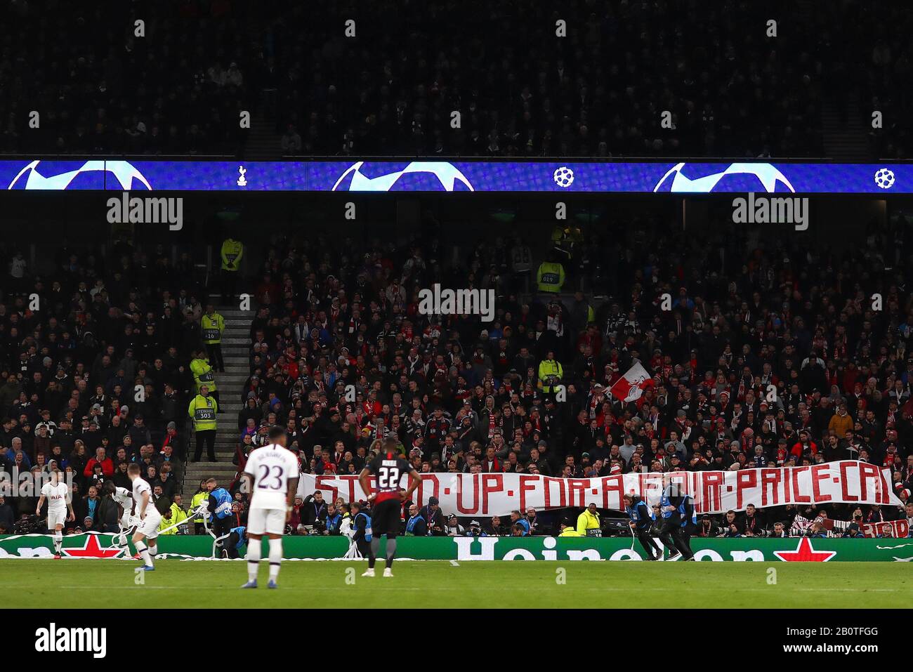 RB Leipzig fans hold up play after throwing ticker tape onto the pitch and displaying up a banner for a fair price cap