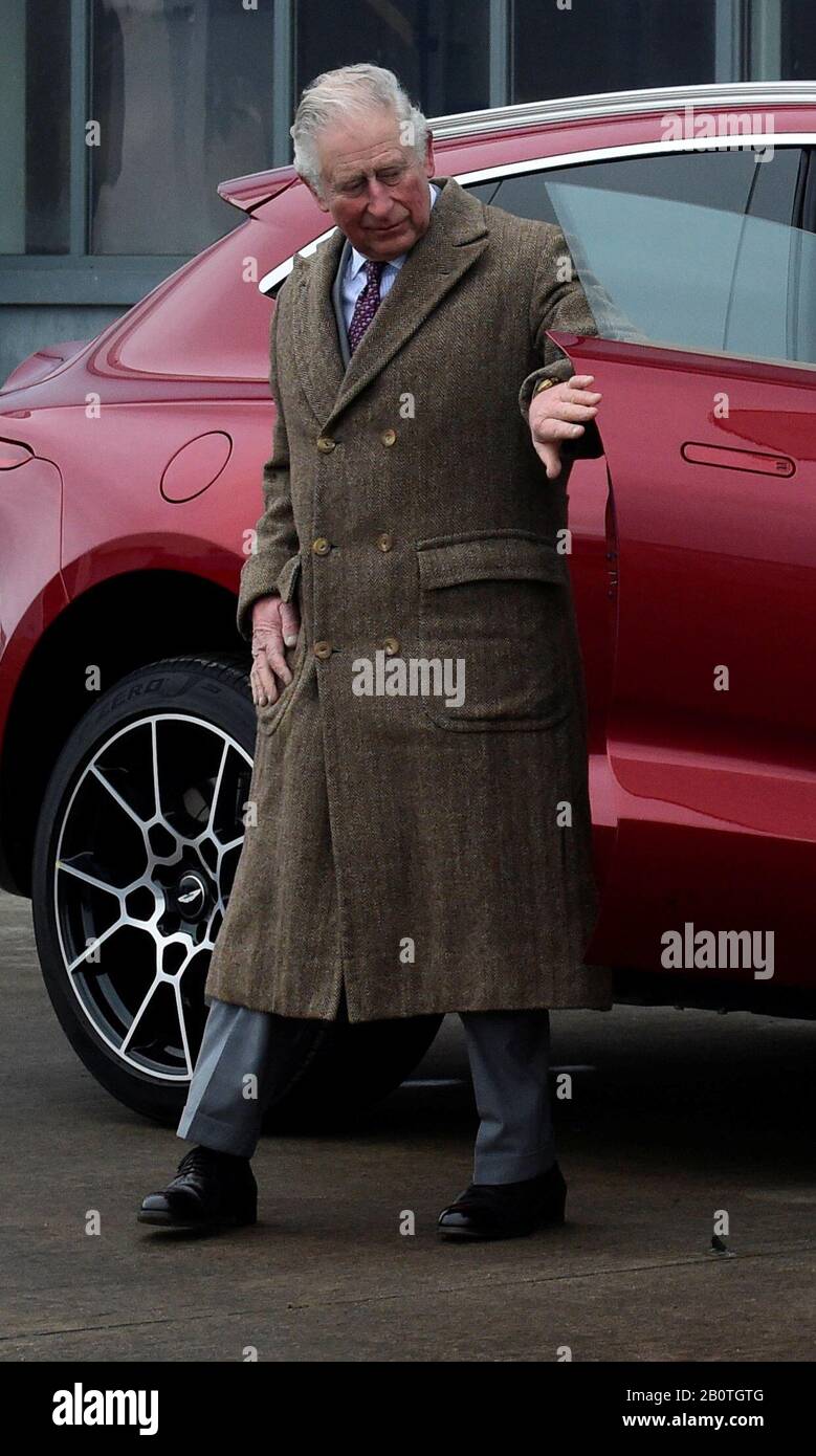 The Prince of Wales looks at the new Aston Martin DBX during a visit to the Aston Martin Lagonda factory at St Athan in Barry, Wales. Stock Photo